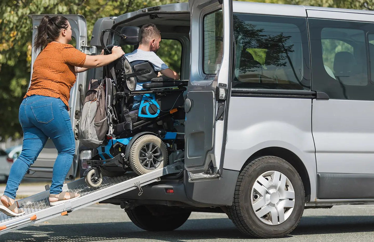 Wheelchair user boarding a patient transport van by ramp - non-emergency medical transportation NEMT insurance